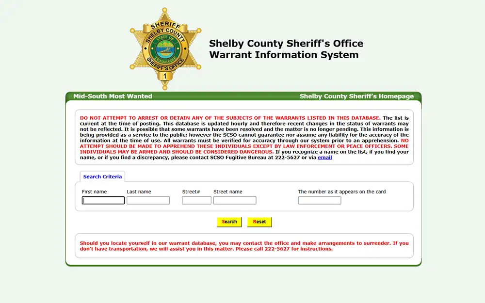 A screenshot from Shelby county sheriff's office warrant information system website showing a reminder, and an empty search criteria.